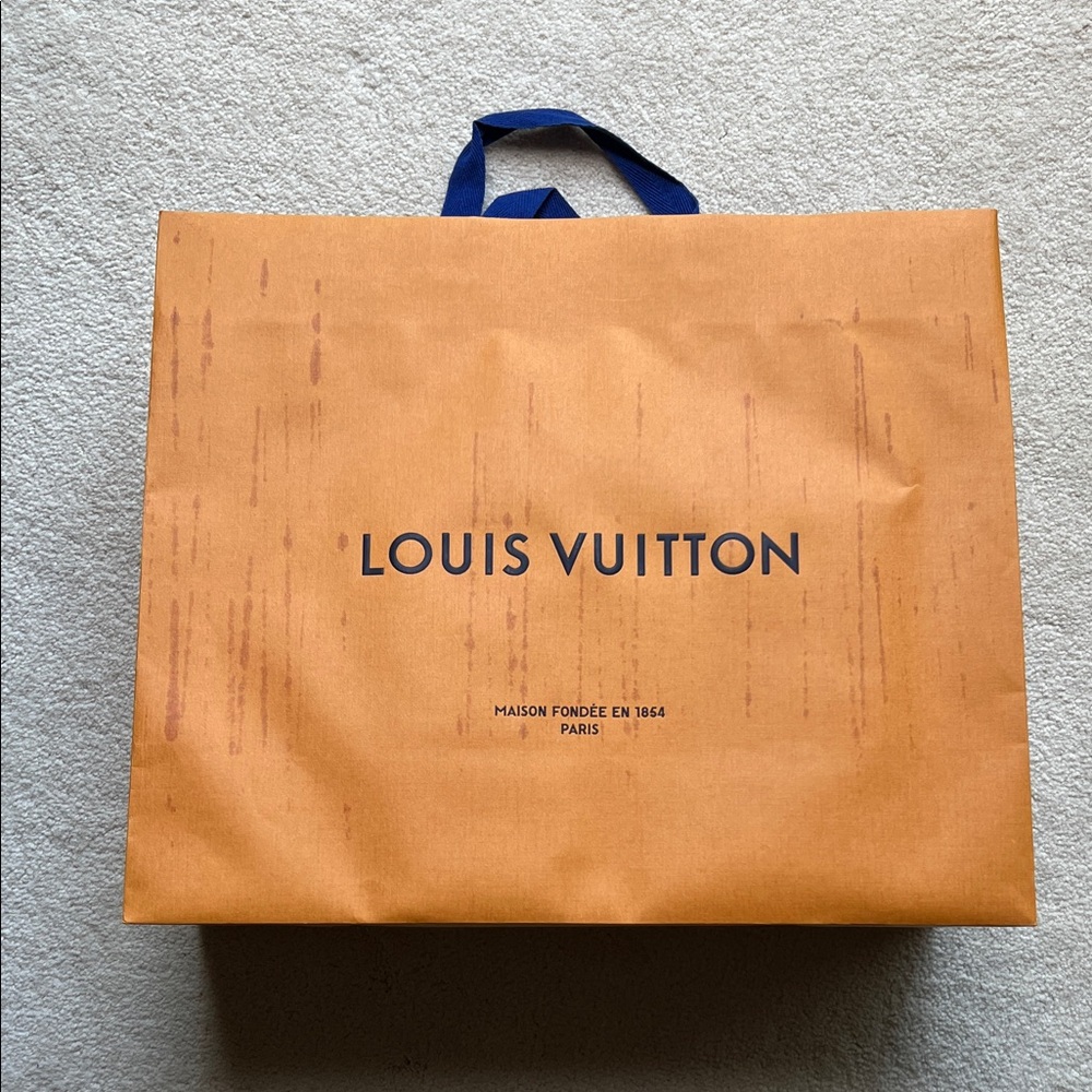Louis Vuitton Shopping Bag 13&1/2”x16x6&1/2” has slight grill marks (see photo)